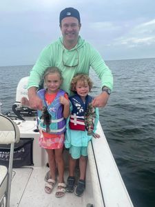 Two gag grouper fish caught in Carrabelle, Florida during cruises and fishing activities.