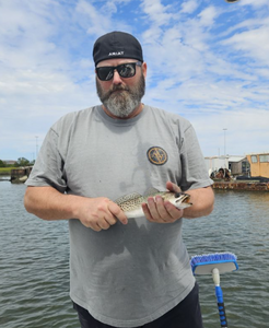 Fisherman reeling in a 7-inch catch in SC