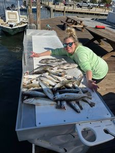 Two anglers fishing in Slidell, Louisiana, with three caught fish