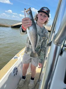 A fisherman catching a spotted weakfish in LA