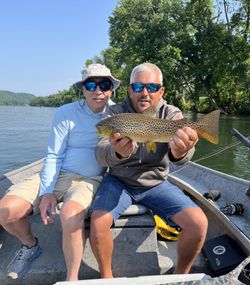 Angler catches rainbow trout in Cotter