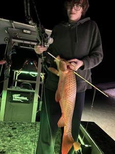 Reeling in a beauty under the night lights.