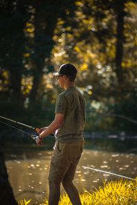 Angler fishing from shoreline in Destin Florida with fishing rod near water