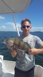 Fishing in Florida - Angler with 14-inch catch