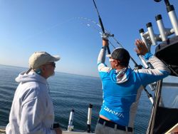 Two people fishing on a boat on Knife River