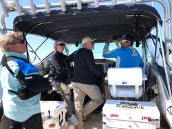 Three people enjoying a fishing cruise on the Knife River