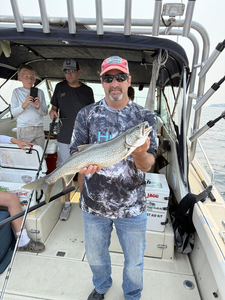 Reeling in a big lake trout while trolling at Knife River Marina!