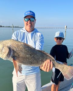 A pair of anglers with a big 31-inch fish caught in TX