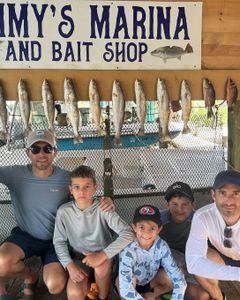 A school of spotted weakfish and grey snapper fish in a coastal TX location