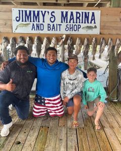 Successful fishing trip at Jimmy's Marina and Bait Shop in Port Isabel TX with multiple fish displayed