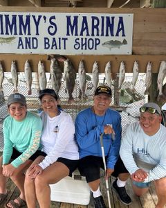 Fishing group displaying their catch of multiple fish species at Jimmy's Marina and Bait Shop in Port Isabel TX