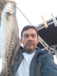 A person enjoys a fishing cruise at Jacksonville Beach