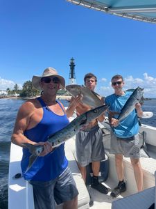 3 people fishing with 2 fish at Pompano Beach