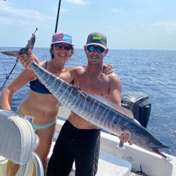 Two anglers with a large freshwater fish caught at Pompano Beach