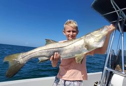 A fisherman holding a large snook in FL