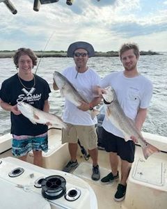 Anglers with three big fish on a fishing trip in NC
