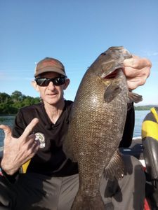A person holds a 27-inch fish while fishing in TN