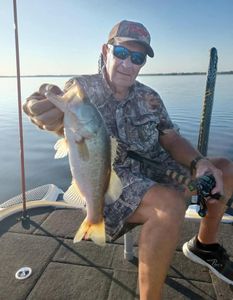 A man fishing for a large largemouth bass in Cleveland