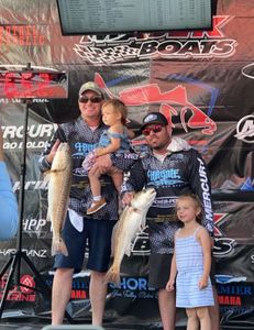 Two people fishing with two large fish in Aransas Pass