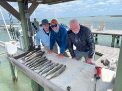Three people fishing in Aransas Pass