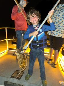 A single fisherman reeling in a catch in Matagorda