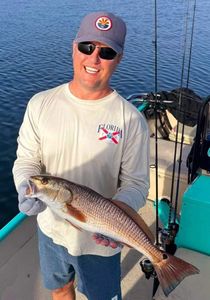 A lone angler reels in their catch in FL