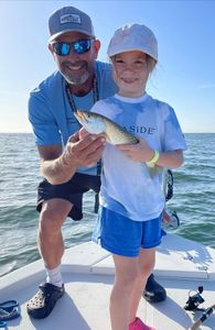 Two anglers fishing in Florida with one small fish