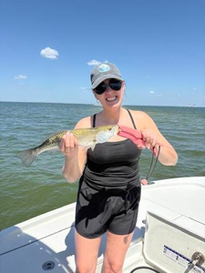 Hauling in the big one on a great day by the water!