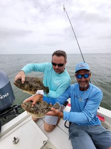 Two summer flounder and southern flounder caught while fishing in FL