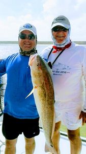 Two anglers with one large fish in Port Isabel
