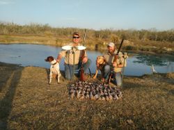 Two people enjoying fishing and hunting activities in the beautiful Port Isabel location