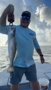 Angler with a spotted weakfish in Matagorda