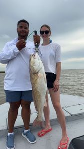 A fisherman holding a 31-inch catch in Matagorda