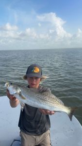 A fisherman holding a 26-inch catch in TX