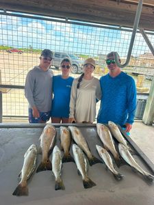 Fresh caught speckled trout and redfish displayed on cleaning table at Matagorda TX fishing dock