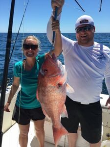 Two people enjoying a fishing trip in FL