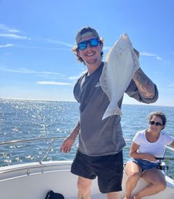 Two people enjoying fishing tours in Longport