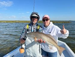 Angler holding a large redfish in Spring Hill