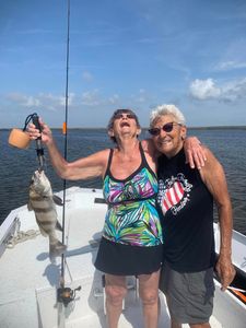 Angler holding a black drum fish caught in FL