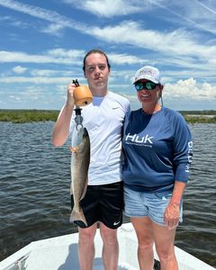 A fisherman holding a 19-inch catch in FL