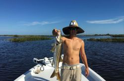 Angler holding a 28-inch snook in FL