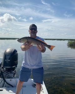 Angler catching a redfish in FL
