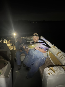 A pair of anglers with a big 38-inch fish, fishing in Norman