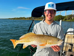Angler holding a large redfish catch in Elmendorf
