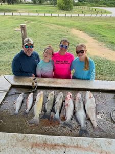 Fishing catch display showing multiple fish species on cleaning table in Elmendorf TX