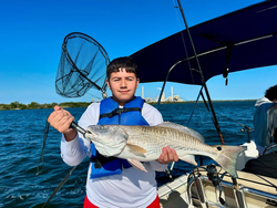 Angler catching a large redfish in Elmendorf