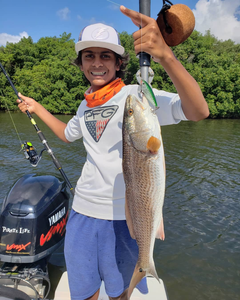 Angler proudly holding a large redfish in Florida