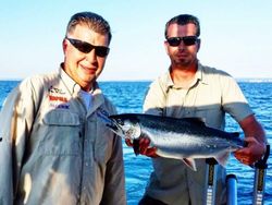 Two people fishing for a single fish in Ontario