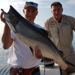 Coho salmon caught by two people fishing in Oakville