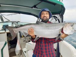 A person fishing in ON with a 35-inch catch